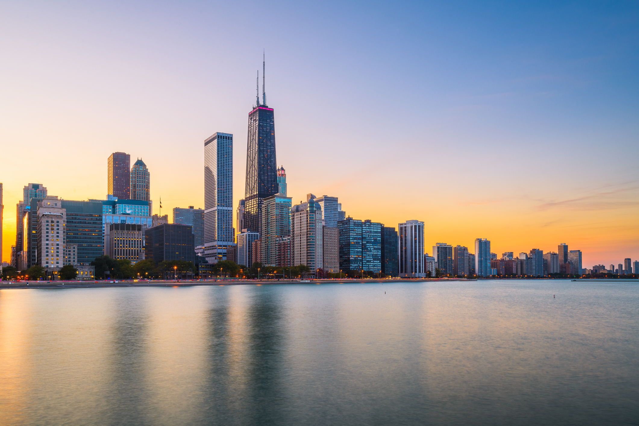 Chicago, Illinois, USA downtown skyline from Lake Michigan at dusk.