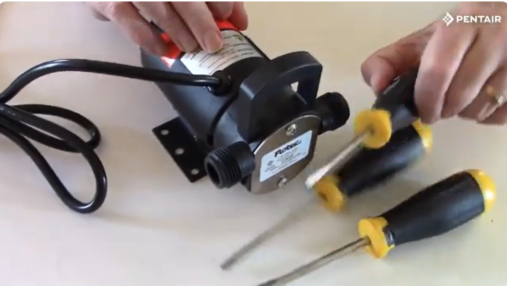 Flotec FP0F360AC CYCLONE™ pump shown being opened with screwdrivers as part of a basic repair.