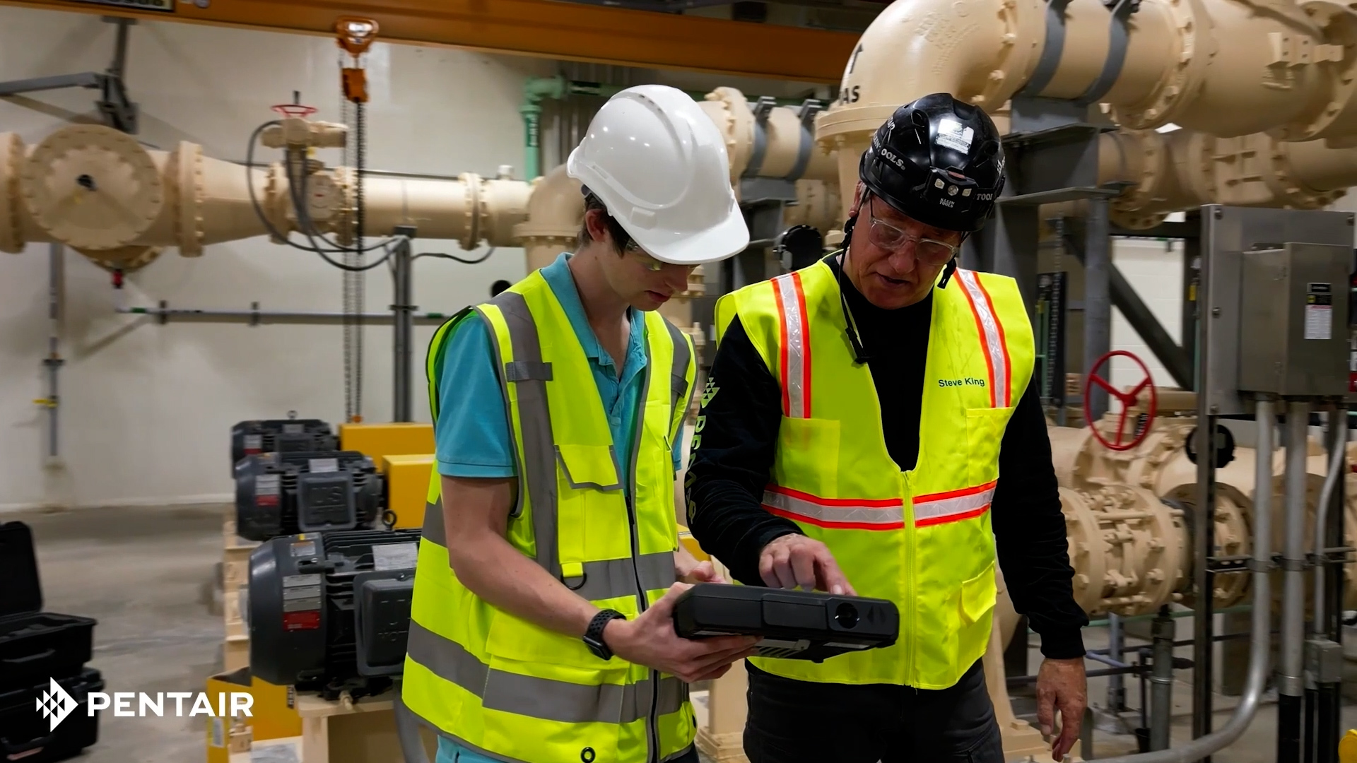 Technicians collaborating with digital tools in an industrial facility
