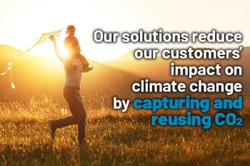 Man with daughter flying kite at sunset, with words on it