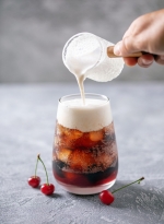 Cherry cola dirty soda in glass. Trending summer drink