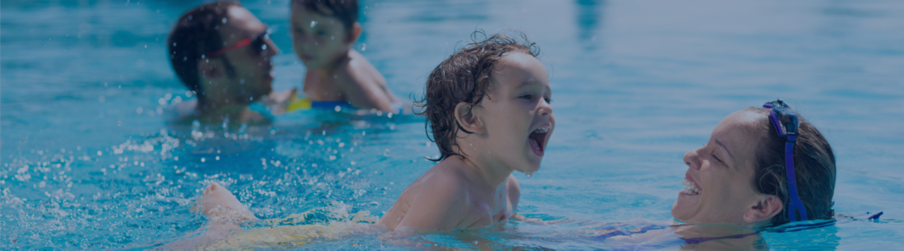 Parents and kids having fun in pool