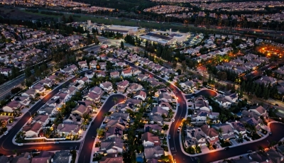 illuminated-suburban-neighborhood-in-tustin-ca-at-nightfall-high-angle-drone-shot.jpg